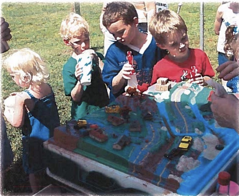 Adolescent children watch the impacts of stormwater run-off on an enviroscape model. (Courtesy of NCDEQ)