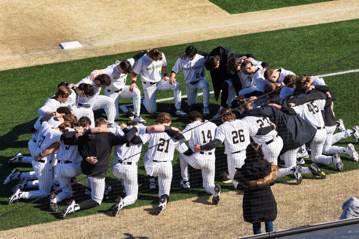 Wake Forest prays before the opening pitch of Friday afternoons game against LIU.