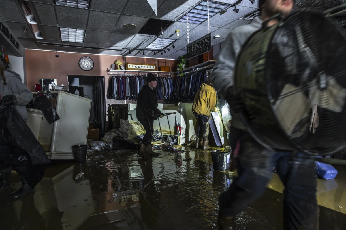 People work to recover clothing from a local business after flooding in Pike County, KY. (Courtesy of the Associated Press)