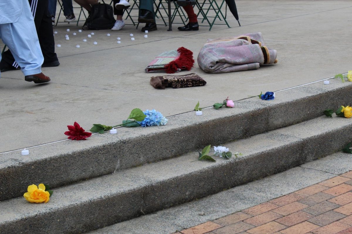 “We Keep Us Safe” lined the stage with faux flowers and candles before setting up for the Friday afternoon prayer.