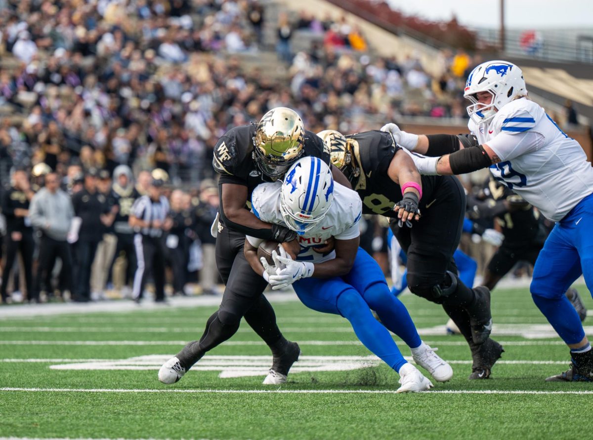 Quincy Bryant (9) bottles up SMU running back T.J. Harden (27) and fights to strip the ball away.
