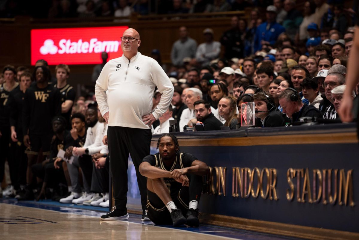 Steve Forbes and the Wake Forest bench react to a call against the Demon Deacons.
