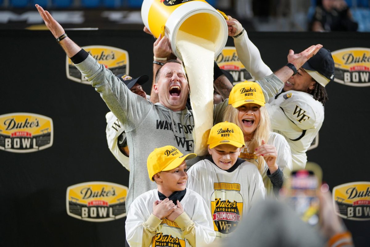 Wake Forest head coach Jake Dickert shares a mayonnaise bath with his children—Rylee, Jett, and Jace.