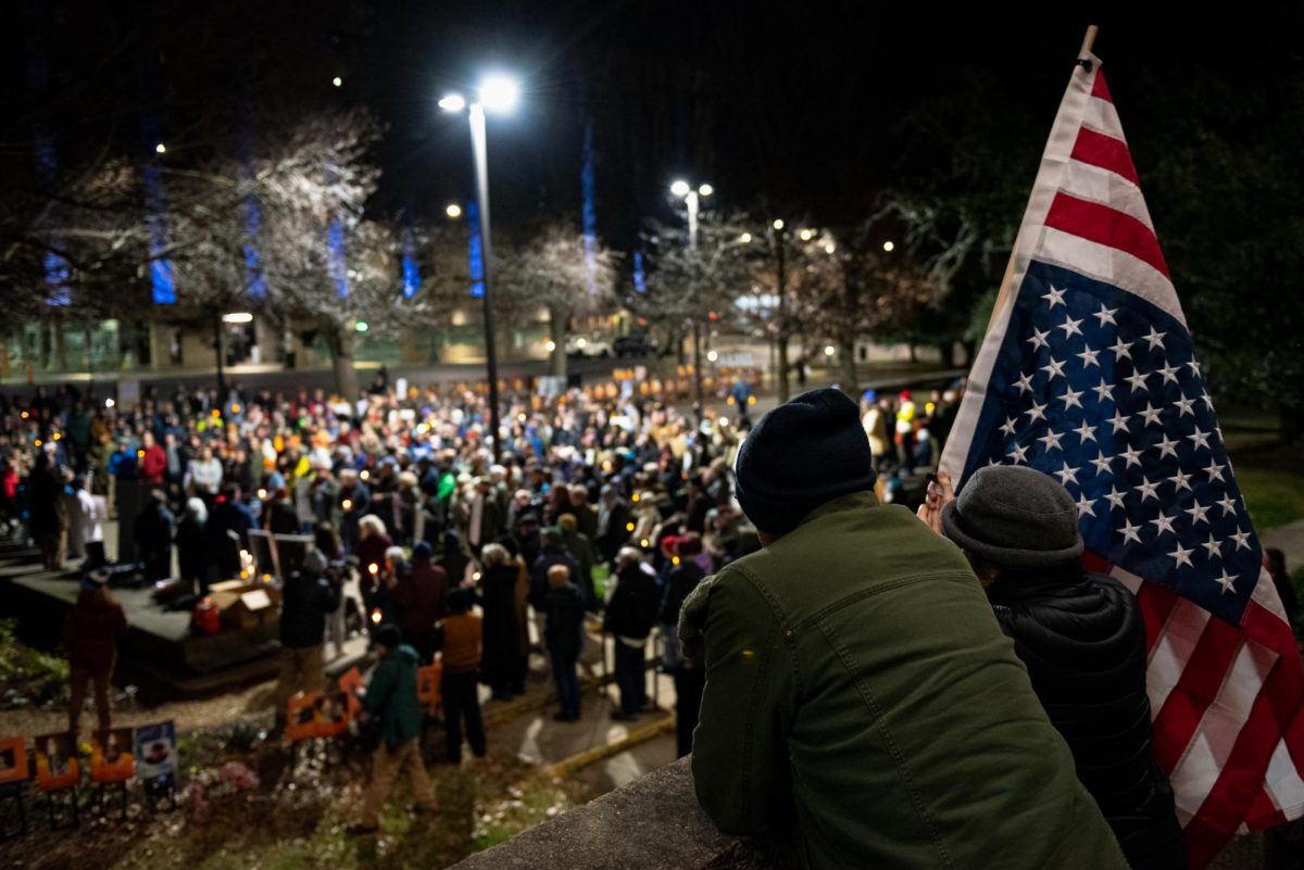 Mourners gather around an altar in front of the Melvin Municipal Office Building in downtown Greensboro. 