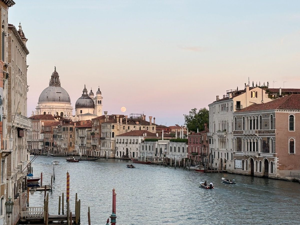 Boats pass by on The Grand Canal in Venice, Italy at sunset. (Courtesy of Harper Ransburg)