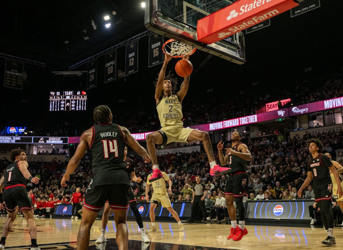 Juke Harris (2) rises above the rim for a thundering dunk, igniting the Joel in Saturday’s game against Louisville. 