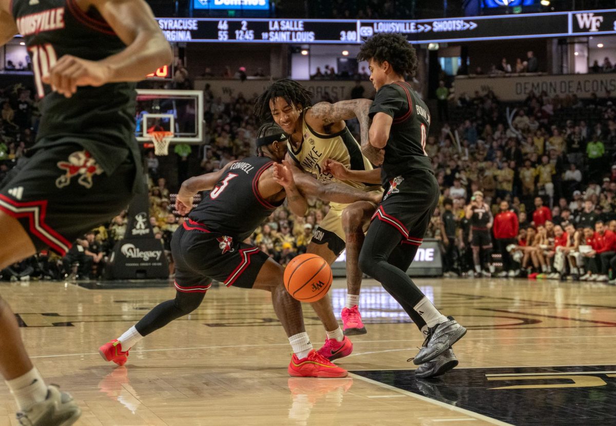 Juke Harris (2) fights through two Louisville defenders.