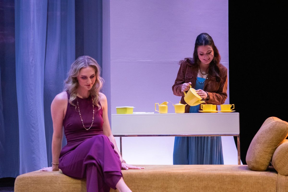 Gabi Velinova makes coffee as she continues a conversation with Ashlyn Collings.