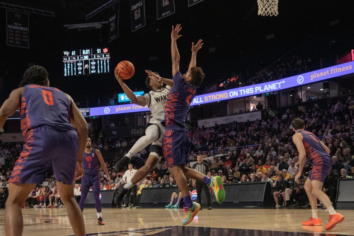 Myles Colvin (6) defies gravity for a contested shot in the paint against Clemson on Feb. 18 at the Joel.
