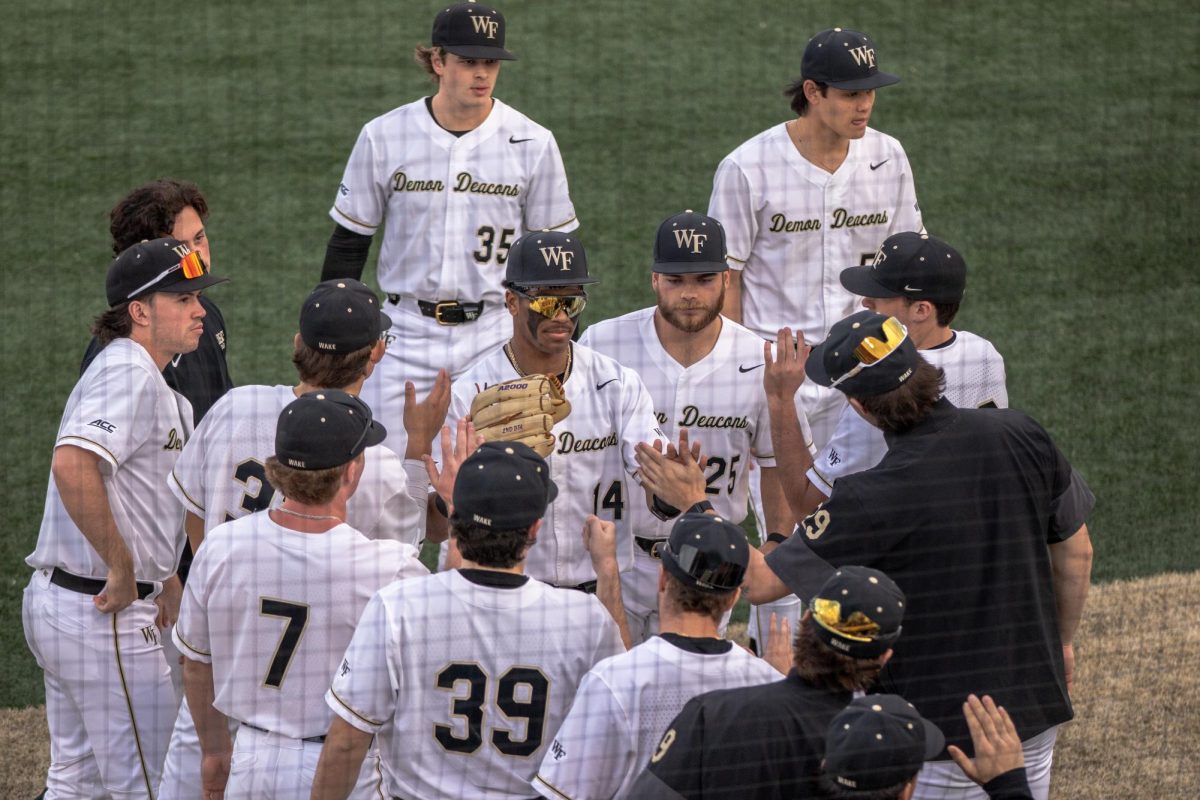 Outfielder Javar Williams heads back towards the dugout, where he is greeted by his teammates in Game 2 on Feb. 21.