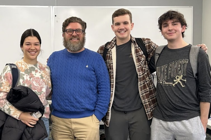 Greene pictured next to students from his Suburban Gothic Literature First Year Seminar course. Provided by Harper Ransburg.