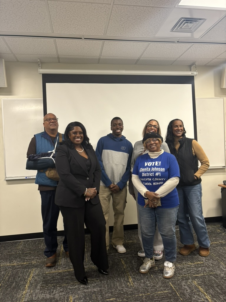Wake Forest College Democrats president Caleb Pembele (center) poses for a photo with local Democratic candidates Howard Claggett, Quamika Shavers, Lauren Tuttle, Amara Hunter and Chenita Johnson. (Courtesy of Eve Darke)