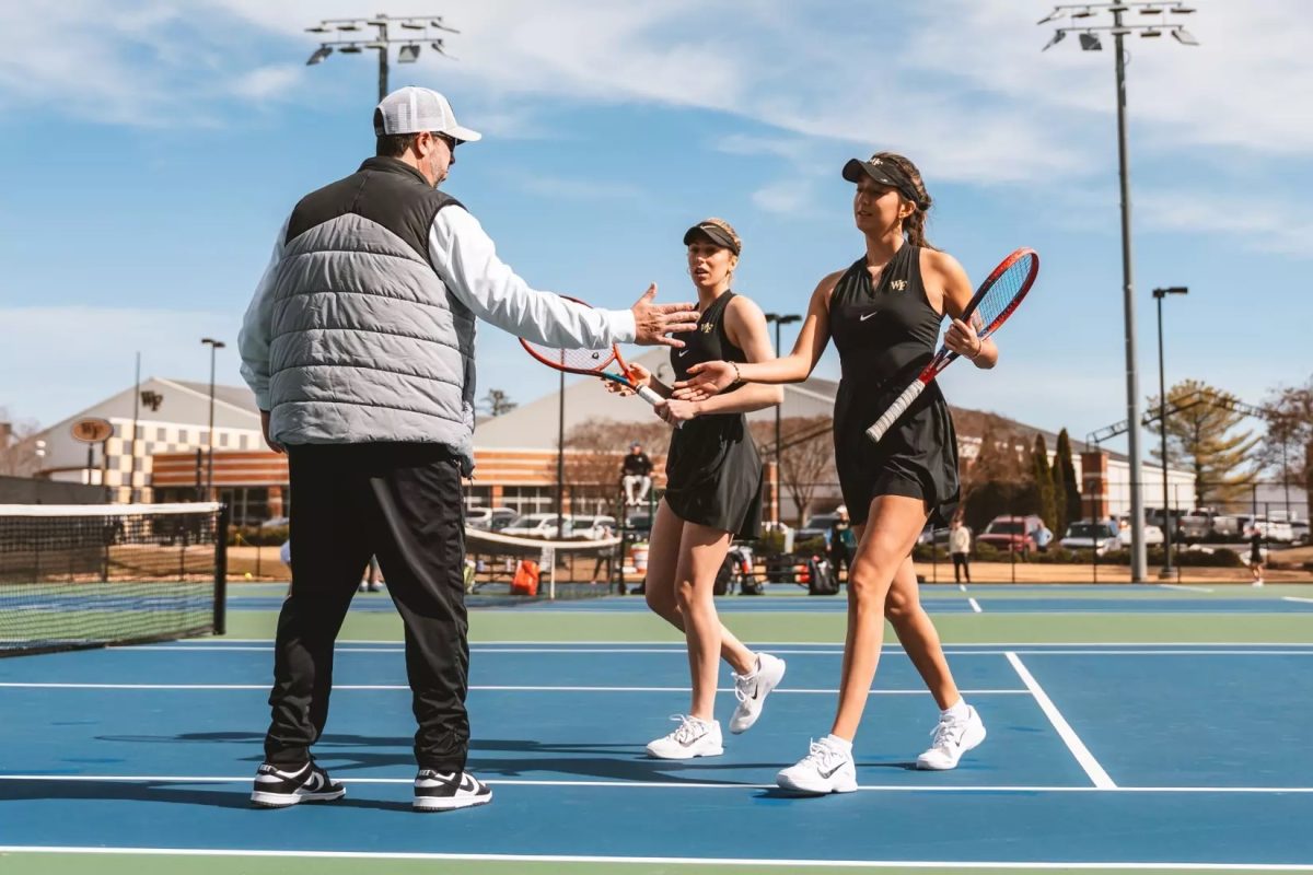 Doubles partners Nevena Carton and Kady Tannenbaum head off the court to greet head coach Jeff Wyshner. (Photo courtesy of Wake Forest Athletics)
