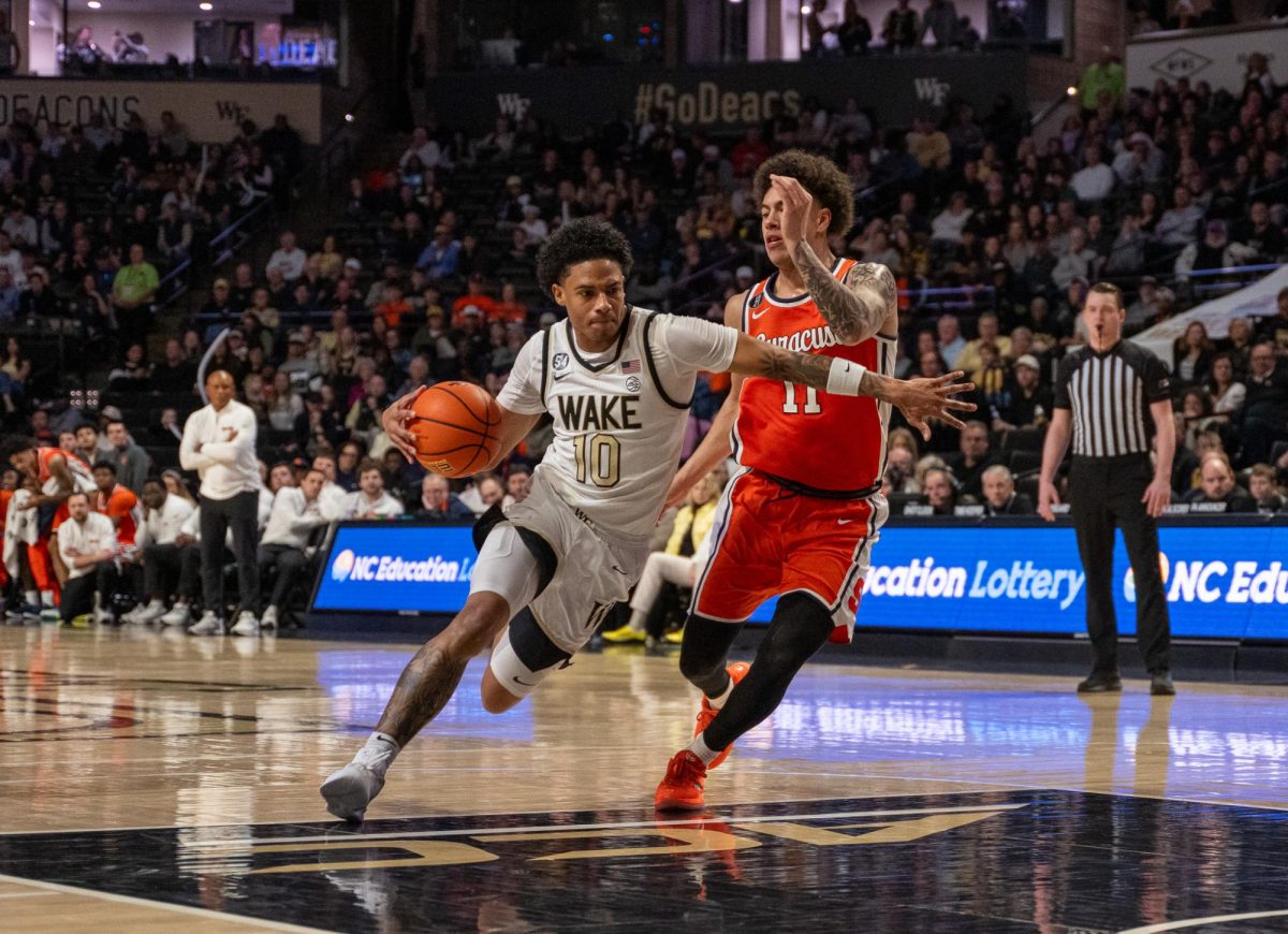 Sophomore guard Sebastian Akins (10) drives in towards the basket against a Syracuse defender.