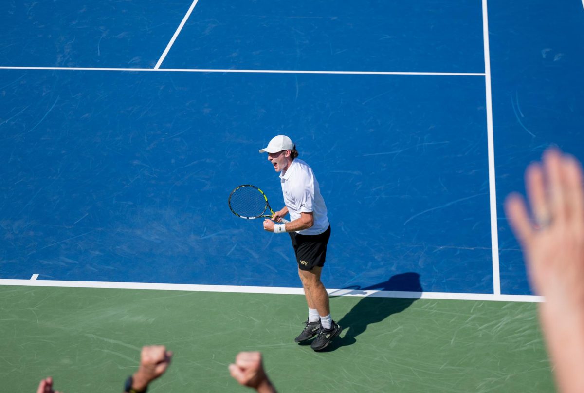 Luca Pow gets the crowd fired up after winning his match to put the Deacs up 2-1.