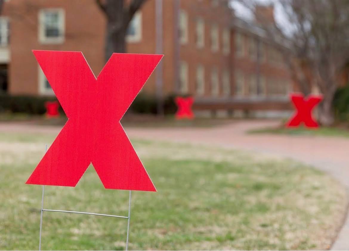 Red TEDx yard signs line Manchester Plaza ahead of this year's TEDxWFU conference. (Courtesy of Bella Santos)