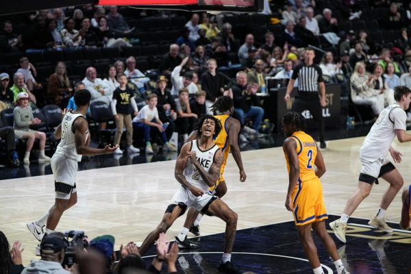 Juke Harris (2) flexes after a two-handed slam at the rim.
